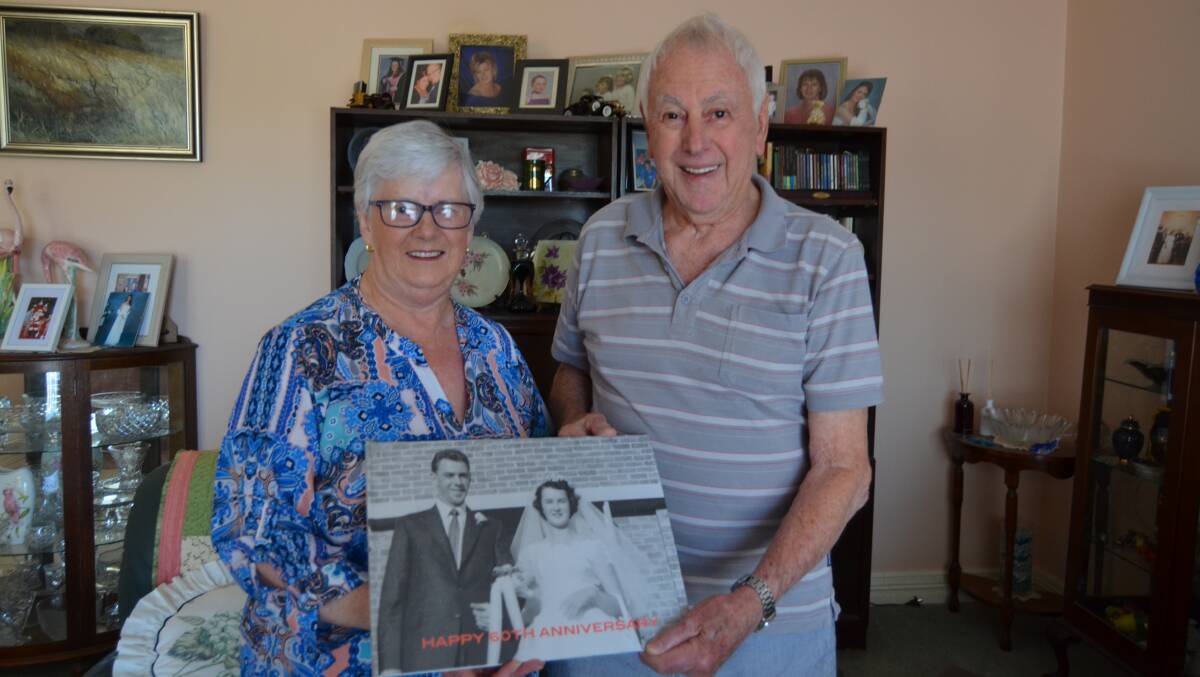 62 YEARS: Pat and Graeme surrounded by family pictures, they are happy to do everything together. Picture: ALISON FOLETTA.