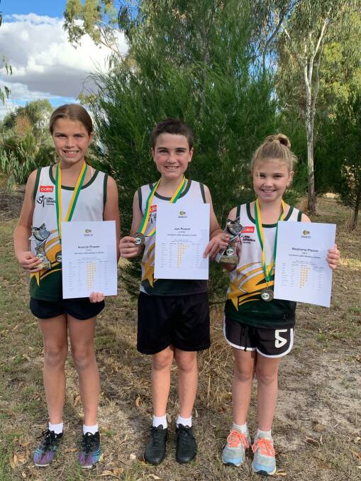 IN THE FAMILY: The Plazzer family - Hannah was the girls under 12 champion, Joel, and Stephanie was the girls under 8 champ. Picture: CONTRIBUTED.
