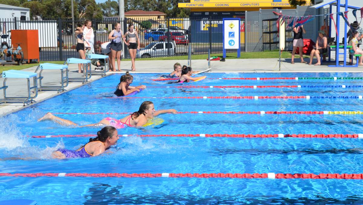 READY SET GO: The swimming board race is off and making a splash. Picture: ALISON FOLETTA.