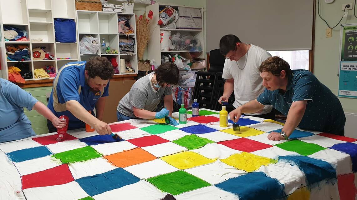 FUN AND GAMES: Grampians DisAbility Advocacy Peer support group making a giant game of snake and ladders. Picture: CONTRIBUTED. 