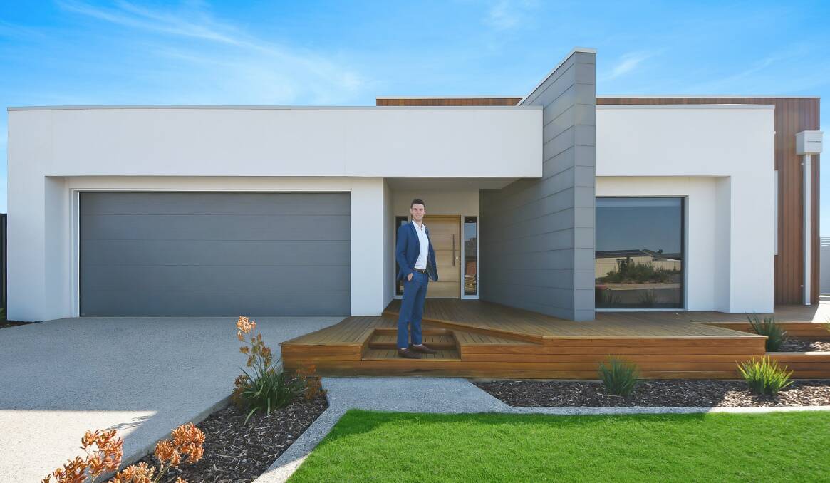 SOLD: Harcourt real estate agent, Taylor Whitworth in front of the luxury home in Tooley court. Picture: CONTRIBUTED.