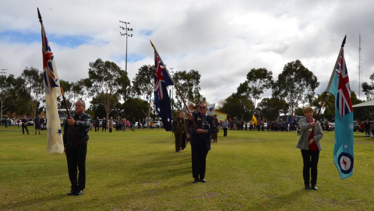 ANZAC: Flag bearers Baz Rompa, Bill Purchase and Sally Bertram. Picture: ALISON FOLETTA.