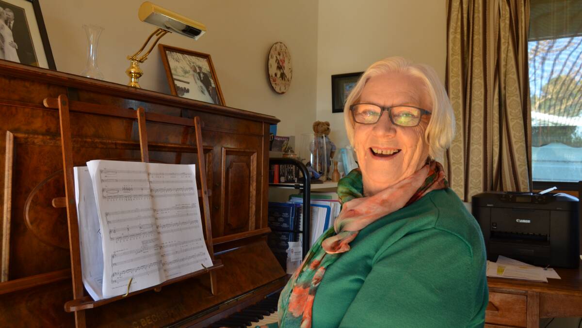 MUSICAL: Shirley Smith sits at her 100-year-old piano which was her mothers wedding present and passed down. Picture: ALISON FOLETTA