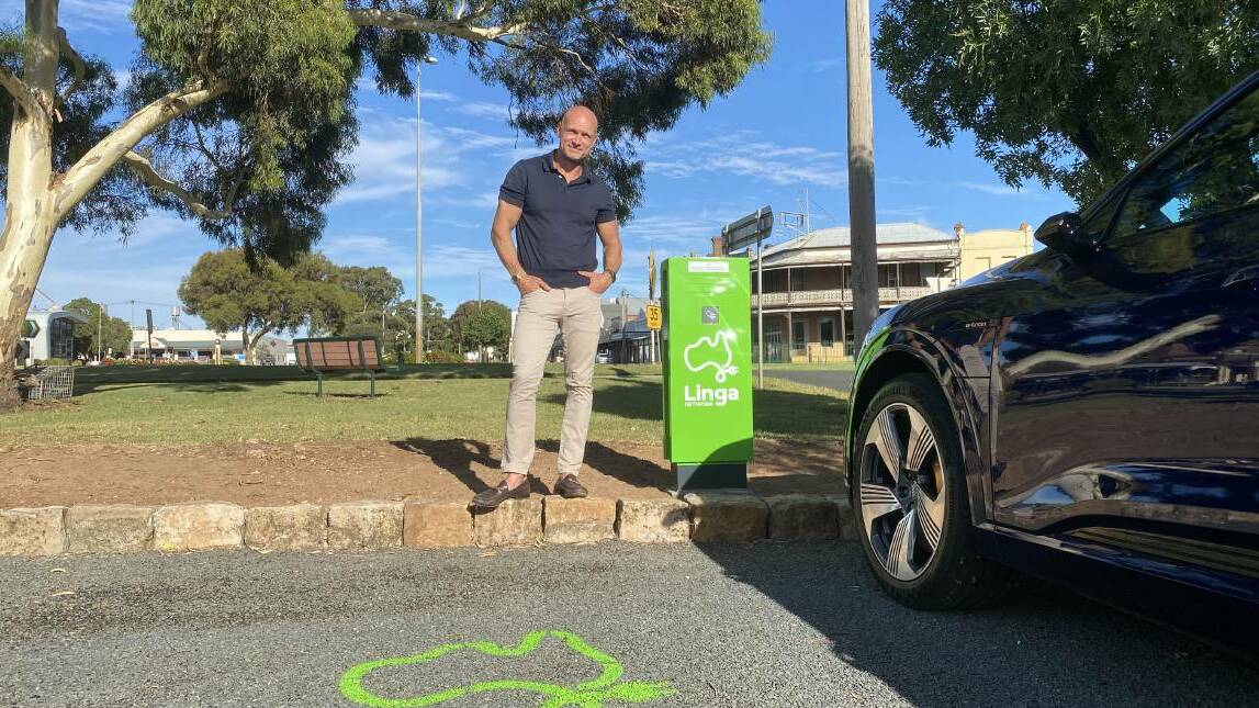 ELECTRIC FUTURE: Linga Network chief executive Adrian Kinderis standing alongside an electric vehicle charging station in Nhill. Picture: CONTRIBUTED
