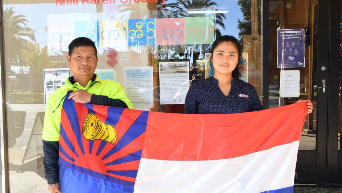 PRIDE: Nhill's Kaw Doh Htoo and Mura Htoo holding the Karen flag at Mr Htoo's Karen grocery store. Picture: ALEX DALZIEL