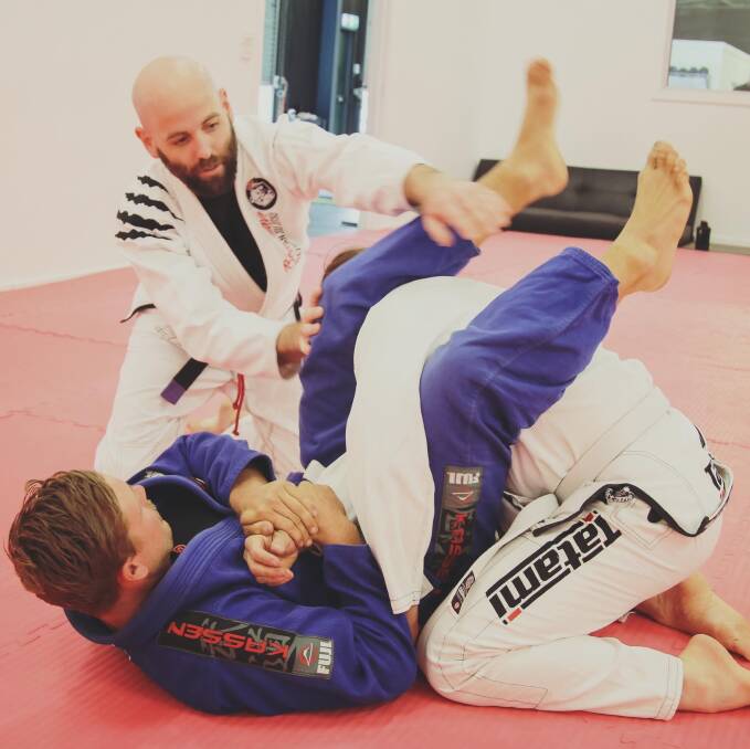 TRAINING: Horsham Brazilian Jiu-Jitsu coach Jesse Millar (left) instructing two students. Picture: CONTRIBUTED