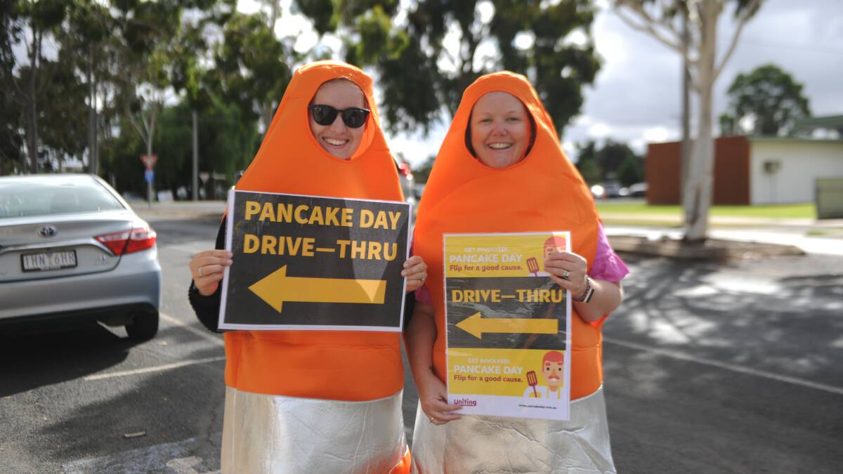 CONES: Hannah Dubois (left), and Kelli Both guided people to the drive-thru pancake station. Picture: ALEX DALZIEL