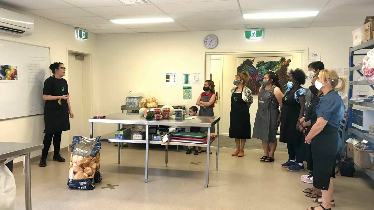 LEARNING: Project manager Jessica Koenig-Fisher teaching participants at the Centre For Participation's kitchen. Picture: CONTRIBUTED