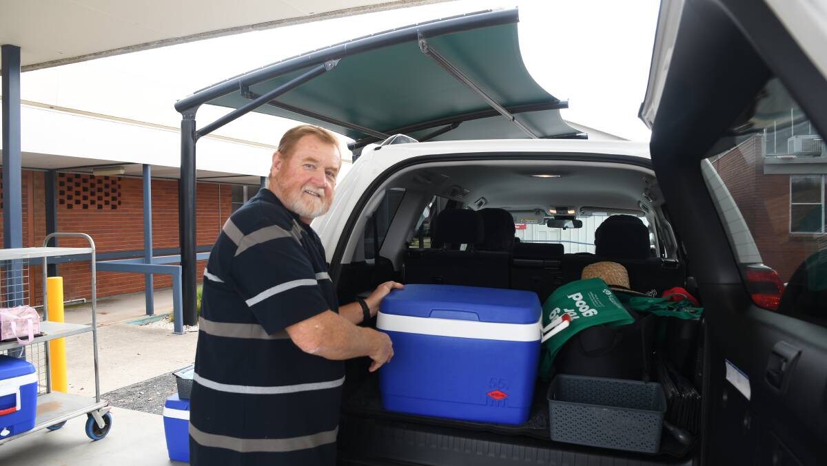 SUPPORT: Mitch King loading an esky of meals into his car at the start of a Meals on Wheels run. Picture: ALEX BLAIN