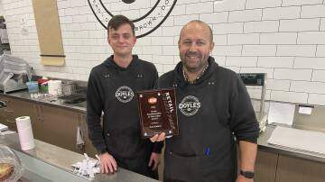 WINNERS: Kaniva IGA staff member Harry McFarlane and owner Lachlan Doyle stand with the store's Retail Transformation and Innovation Award. Picture: ALEX DALZIEL
