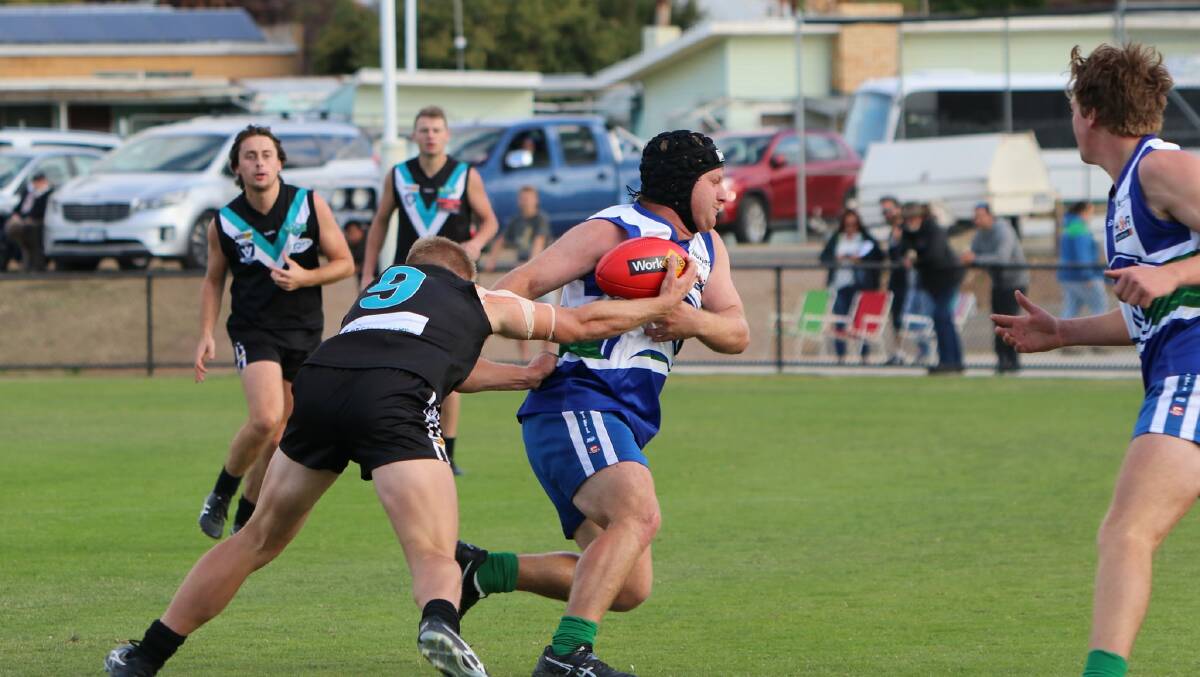 DON'T-ARGUE: Kaniva-Leeor's Liam Vivian attempts to fend off a determined Stawell opponent during their round two clash. Picture: TRISH RALPH