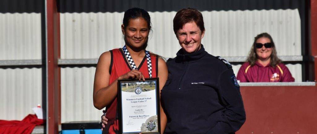 Vanilla Ika receives her award from leading senior constable Jo Orr.