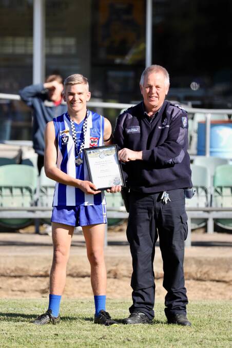 Maddox Blake receives his award from leading senior constable Alan Perry.