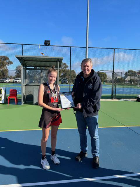 STAR: Emmerson Lawes photographed receiving her award from Blue Ribbon Foundation member Les Power at Quantong Recreation Reserve. 