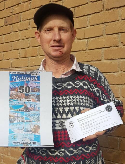 HOLDING DREAMS: Natimuk show committee member James McCredden holding one of the raffle tickets. Picture: CONTRIBUTED