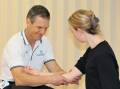 HELPING HAND: Chief physiotherapist Ben Wiessner helps a client with an arm injury. Picture: CONTRIBUTED