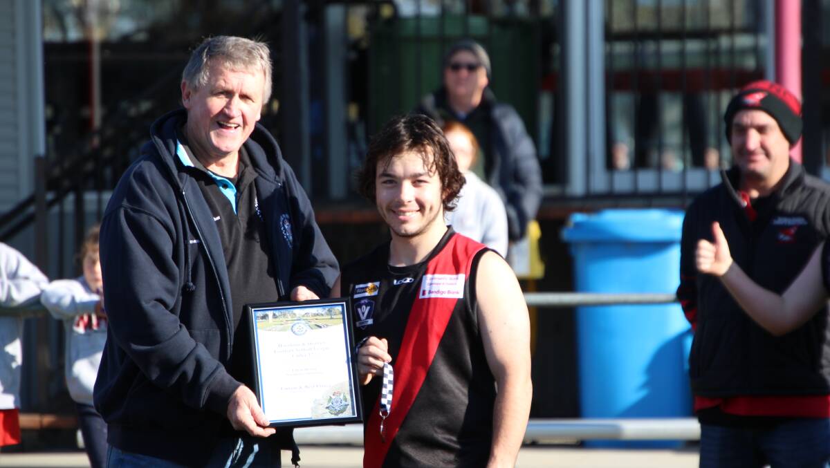 WINNER: Ethan Heard photographed receiving his award from Blue Ribbon Foundation member Les Power before the game at Quantong Recreation Reserve. 