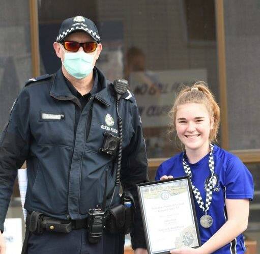 SHINING BRIGHT: Amelia Leith photographed receiving her award at the netball from Murtoa Police Officer First Constable Steven Carrigg at Minyip. 