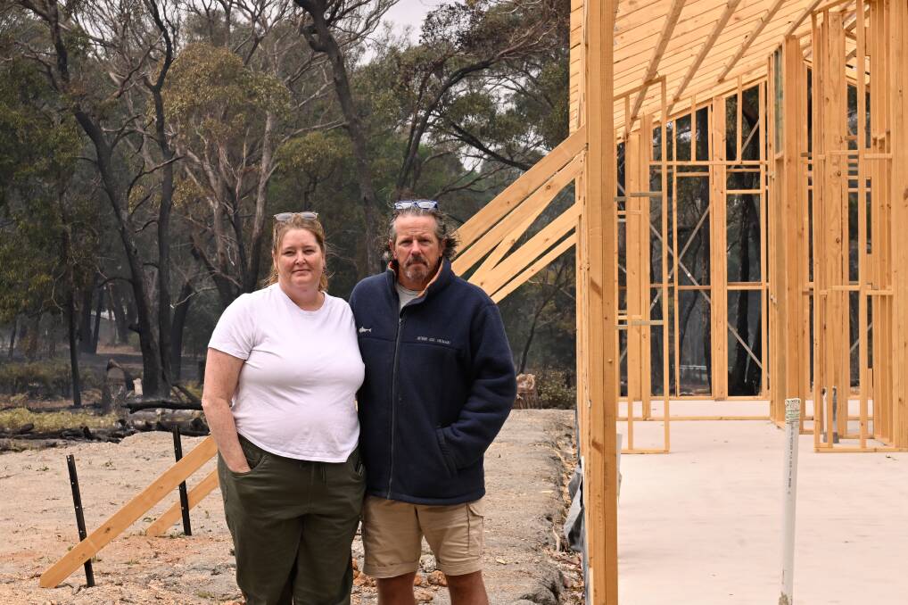 Dean and Chelley Picken were relieved to find their partially built home on Main Lead road still standing with burnt ground all around the perimiter of the property. Picture by Adam Trafford
