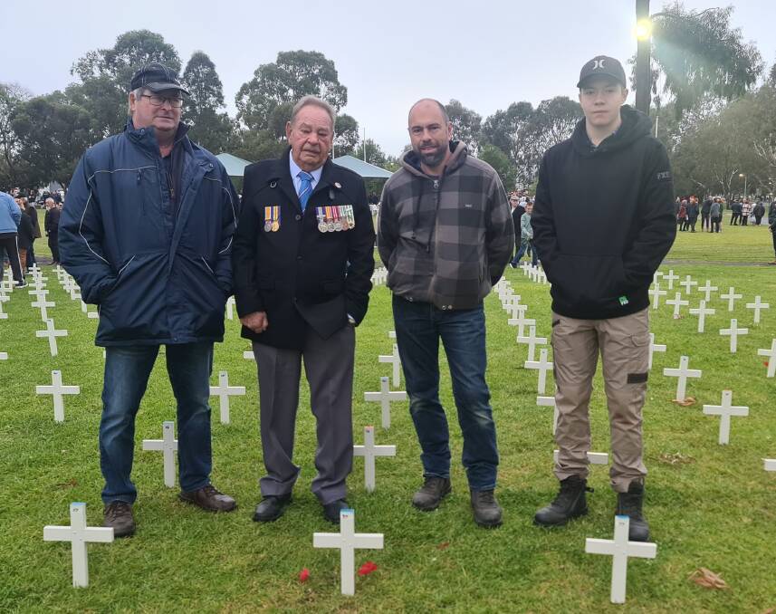 Vietnam Veteran Rex Dumesny (second from left), with relatives Trevor, Andrew, and Jordan Dumesny, placed poppies at the cross bearing their uncle's name A Dumesny, who served and was wounded in France in WW!!. Picture by Sheryl Lowe