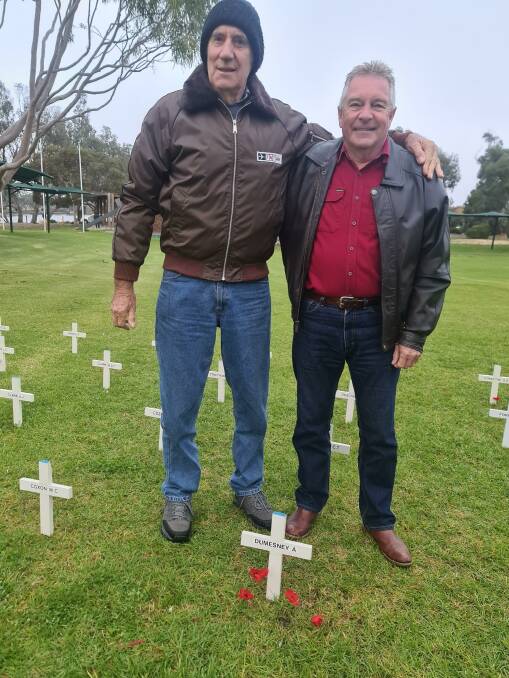 Jim Dumesny placed a poppy at his father's cross, Alfred Dumesny, who served in the Airforce in New Guinea and the Pacific in WWII. Picture with friend Christopher Leskie Picture by Sheryl Lowe