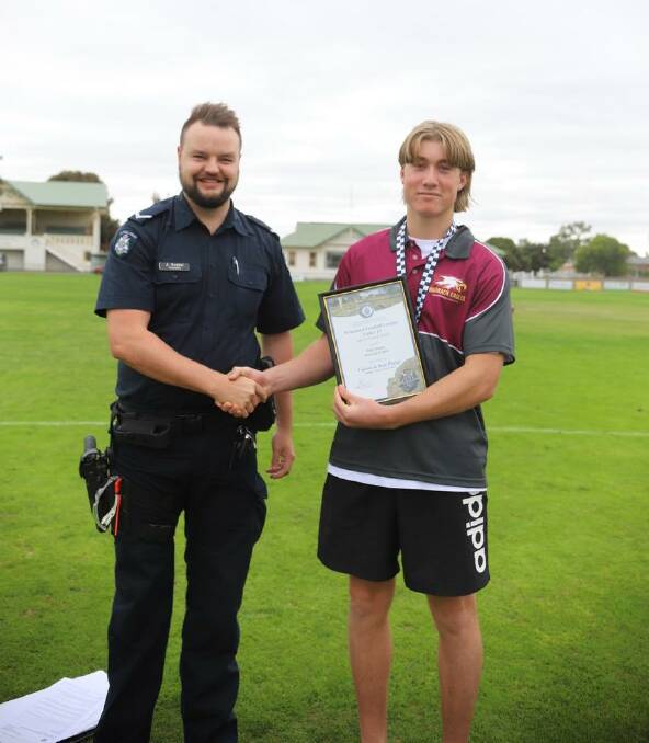 Warrack Eagles' Max Inkster received his Blue Ribbon Spirit of Football award from Warracknabeal police officer, First Officer Jake Goebel. Picture supplied. 