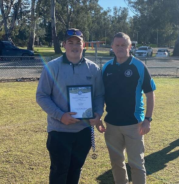 Dimboola Under 17s footballer Caleb Bond receives his Blue Ribbon Foundation Spirit of Football award from foundation member Les Power. Picture supplied