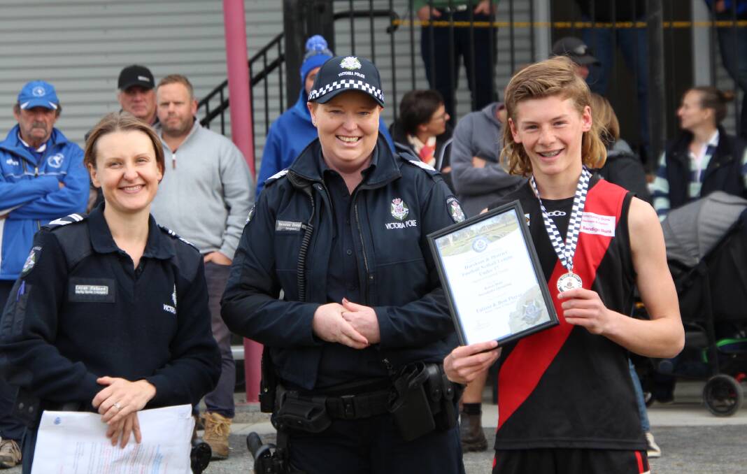 Noradjuha Quantong footballer Rosco Hair is presented his Blue Ribbon Foundation Spirit of Football award by Horsham police officers Leading Senior Constable Teilah Rabone and Sergeant Veronica Dempsey. Picture supplied 