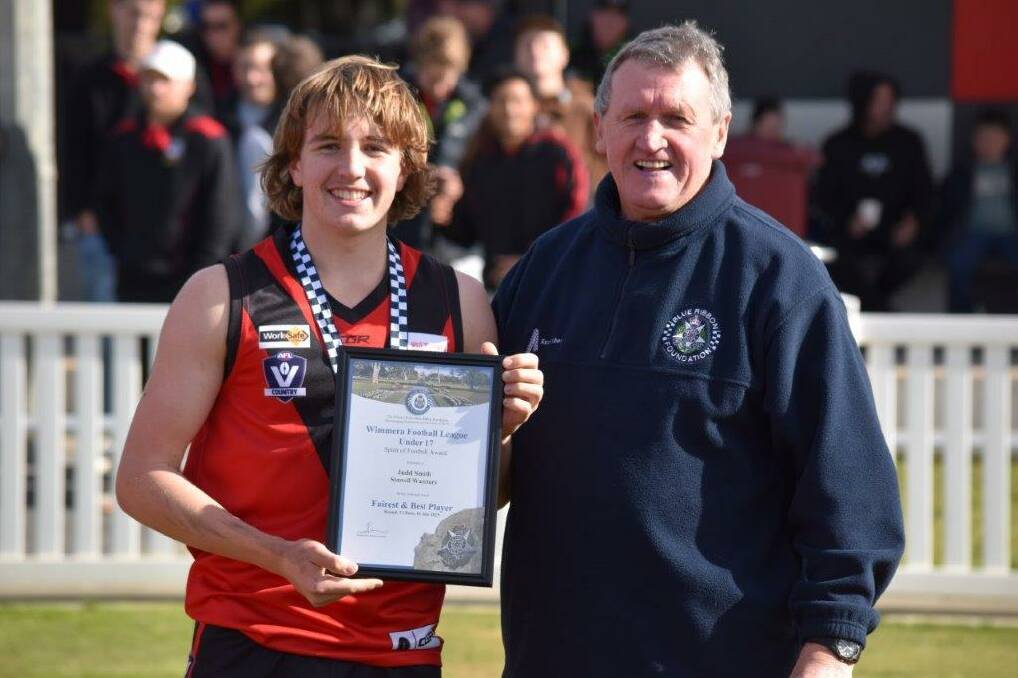 Stawell Warriors Under 17s footballer Judd Smith is presented his Blue Ribbon Foundation Spirit of Football award by foundation member Les Power. Picture supplied