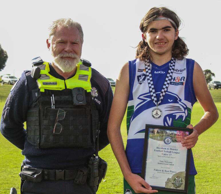 Kaniva Leeor United footballer Toby Mulraney is presented his Blue Ribbon foundation Spirit of Football award by Kaniva police officer, Sergeant Darren Wright. Picture supplied 