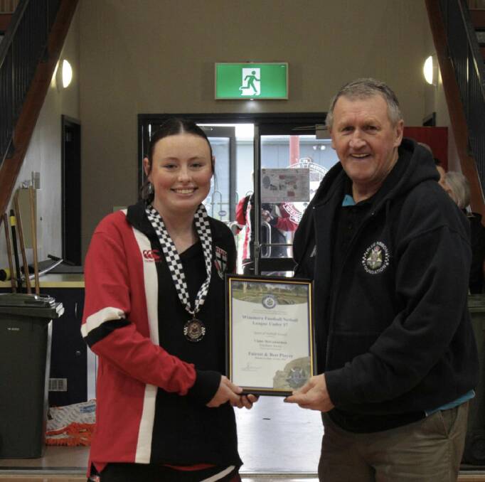 Violet McGennisken is presented her Blue Ribbon Foundation Spirit of Netball award by foundation member Les Power. Picture supplied