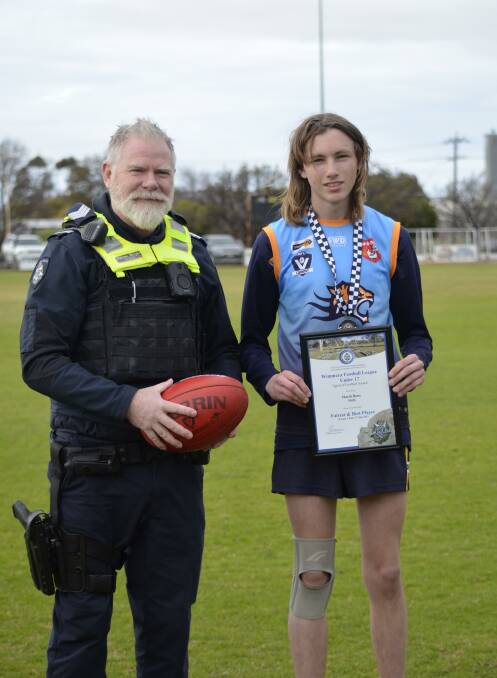 Nhill Tigers Under 17s footballer Mardi Bone is presented his Blue Ribbon Foundation Spirit of Football award by Kaniva police officer, Sergeant Darren Wright. Picture supplied