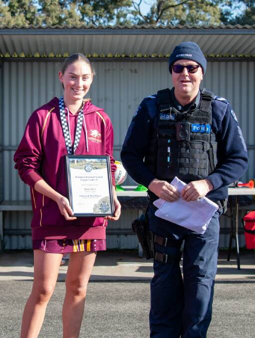 Warrack's Maggie McCoy is presented her Blue Ribbon Foundation Spirit of Netball award by Beulah police officer, Leading Senior Constable Shayne Riggall. Picture supplied