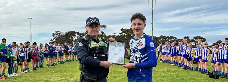 Kaniva Leeor United's Bronte Hiscock receives his Blue Ribbon Foundation Spirit of Football award from Horsham police officer, Senior Constable David Piera. Picture supplied 