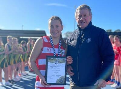 Ararat's Demi Bligh is presented her Blue Ribbon Foundation Spirit of Netball award by foundation member Les Power. Picture supplied