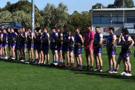 Members of the Horsham Demons observe the pre-match Anzac ceremony in 2023. Picture file