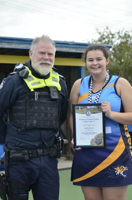 Nhill Tiger Bonnie Gordon was presented her Blue Ribbon Foundation Spirit of Sport award by Kaniva police officer, Sergeant Darren Wright. Picture supplied