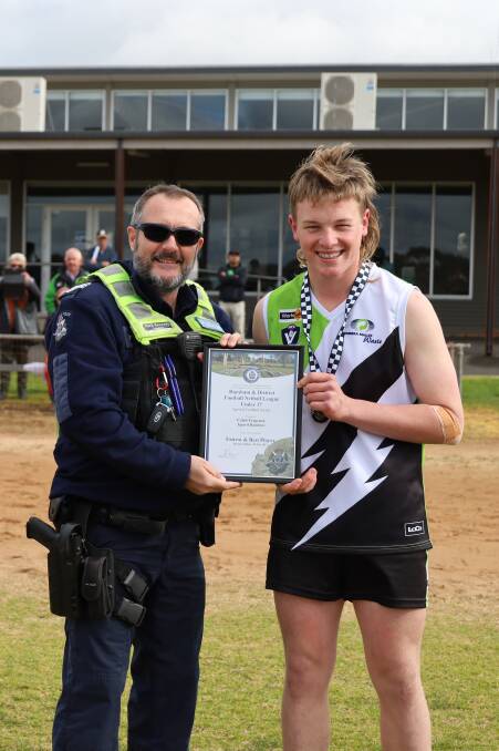 Jeparit Rainbow Under 17 footballer Caleb Tregenza is presented his Blue Ribbon Foundation Spirit of Football award by Nhill police officer, Mark Kennedy. Picture supplied