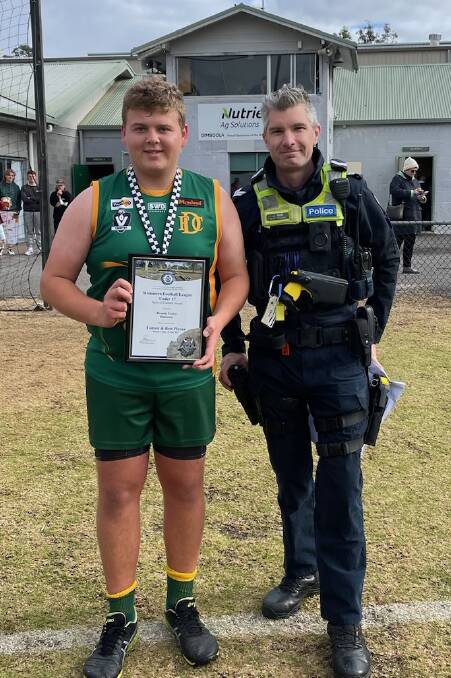 Dimboola footballer Brodie Foster is presented his Blue Ribbon Foundation Spirit of Football award by Horsham police officer, First Constable John Hunt. Picture supplied