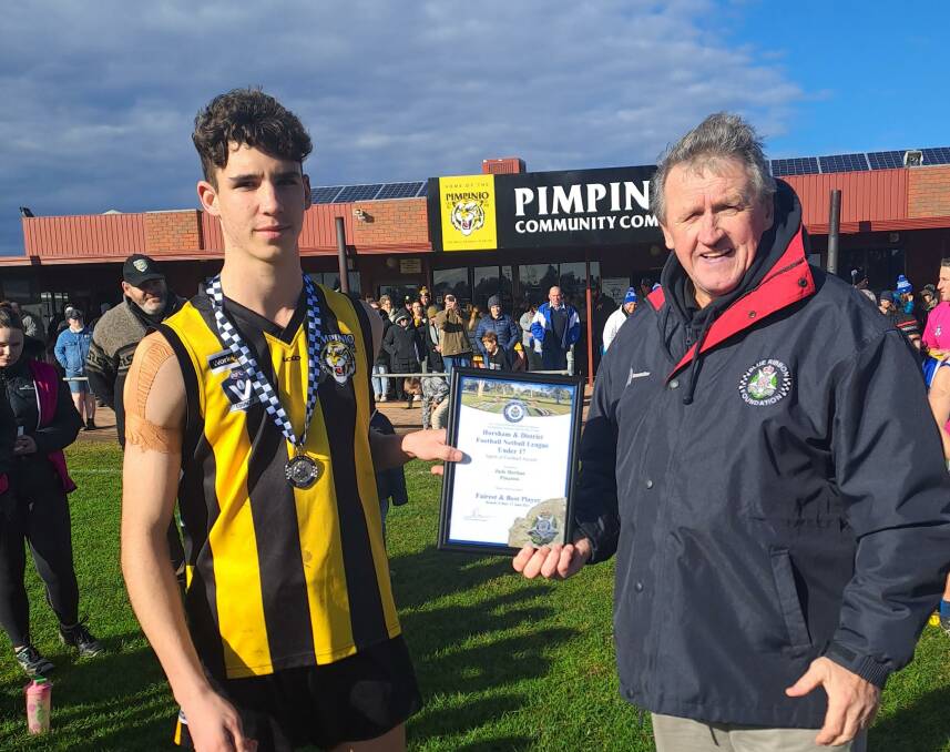 Pimpinio's Jude Borlase receives is Blue Ribbon Foundation Spirit of Football award from foundation member Les Power. Picture supplied 