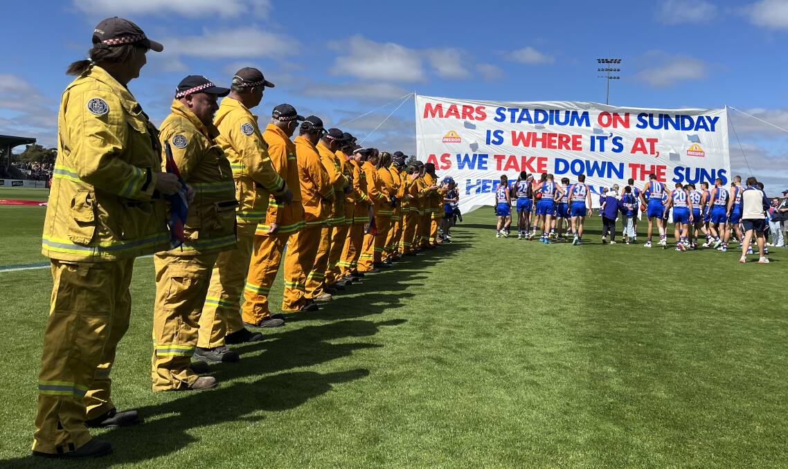CFA volunteers form a guard of honour as Western Bulldogs ran out onto Mars Stadium. Picture supplied