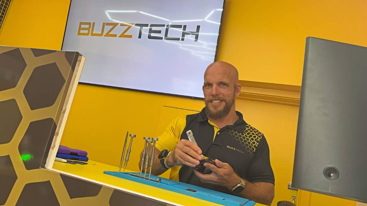 Buzztech chief executive Rhett McGuiness working out of his company's new store in Horsham. Picture by John Hall