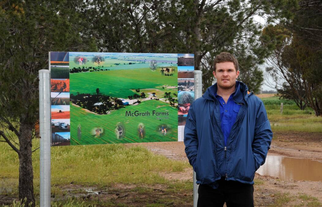 Thomas McGrath with a sign on his family farm.