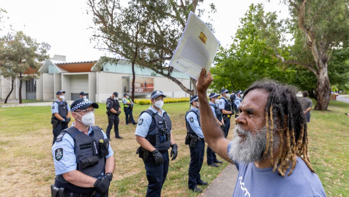 A man who gave his name as Uncle Bruce faces off with police in Parkes on Thursday after a camp was cleared. Picture: Sitthixay Ditthavong
