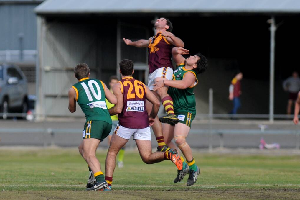 Eagle Scott Adams soars above Roo Jackson O'Neill during the 2015 season. The Eagles will play every 2016 Wimmera league game in Warracknabeal while the Brim Football Ground is redeveloped. Picture: SAMANTHA CAMARRI