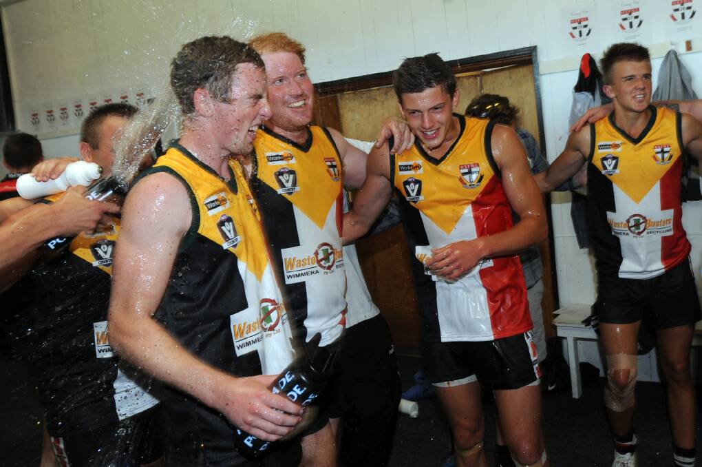 CELEBRATION: Darcy Tucker, second from right, gets around former Horsham Saints teammates after a win against Minyip-Murtoa in 2013. Picture: PAUL CARRACHER