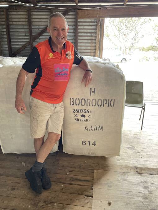 Geoff Brooker with a bale of the Hawkins family's Booroopki wool featuring his own special 50 year stencil, awarded by AWEX for his services to the industry. 