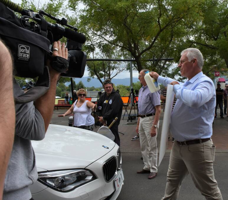 NOT SO FAST: Shoalhaven dairy farmer Robert Miller stands between the PM's convoy and the way out of Nowra on a one-way street at Jellybean Park on Friday. Picture: Rebecca Fist