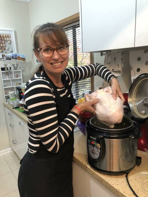 ON THE BOIL: Yolande Grosser puts another chicken in the pot for her Hearty Chicken and Corn Chowder. Picture: SUPPLIED 