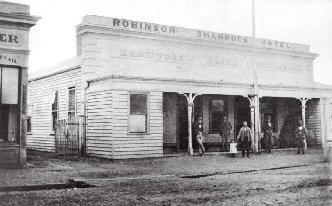 The Shamrock Hotel in 1877. The publican, William Robinson, is the central figure holding the hand of his three-year-old daughter, Margaret. [Source: HHS 039531 (c)]